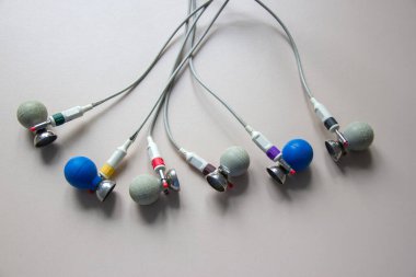 On the table is a suction cup for an electrocardiograph. On a gray background.