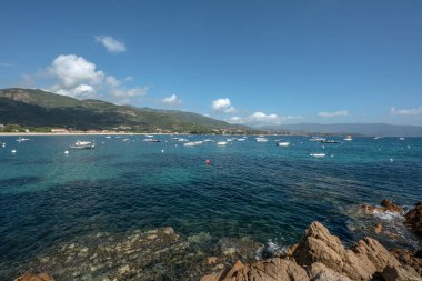 Sagone Korsika 'daki muhteşem golf sahili güzel kumsal tekneleri ve dağ köyü turizmi ve tatil konsepti