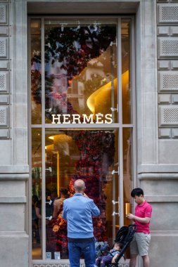 Barselona, İspanya-29 Nisan 2023.Herms, Fransız moda evi, deri aksesuarlar ve lüks saatler konusunda uzmanlaşmış. Bir at arabasının logosuyla tanınıyor. Girişteki logo..