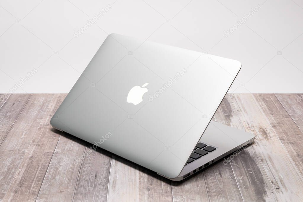 DRESDEN, GERMANY - 31. October 2025: Apple MacBook Pro Early 2015 in the color silver. Laptop computer in a close-up. Backside with the illuminated Apple logo sign.