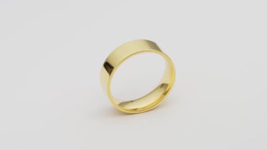 Altın halka, beyazın üzerinde tek başına dönüyor. Sade geniş alyans, altın sarısı renginde. Mücevher ya da elmas gibi bir özelliği yok. Oluksuz cilalanmış yüzey.