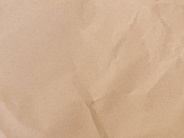 Kahverengi kağıt desenli arka plan. İplik ve düzensiz elementlerle geri dönüştürülmüş madde. Paketin kırışıklıklar ve kıvrımlarla soyut arkaplanı.