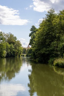Bamberg, Bavyera, Almanya 'da Erba Adası (Erbainsel) yakınlarındaki nehirde tekne turu, doğa, yeşil nehir manzarası ve Avrupa seyahatlerinin dinlendirici durağı ile çevrili manzaralı su yolu.