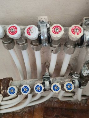 Close-up of radiant floor heating manifold with white pex pipes and valves. Varna. Bulgaria.  09.10.2025