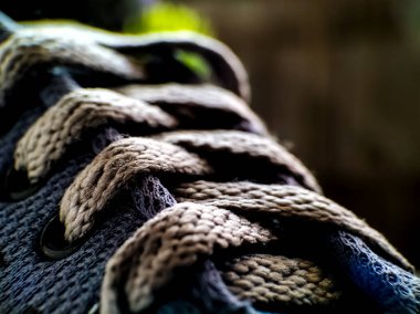 A close-up image of intertwined shoelaces