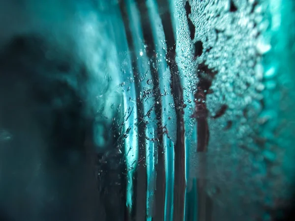 Rippling blue ice cube creates a dynamic abstract background.