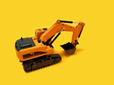 Saf sarı arkaplanda oyuncak kazıcı.