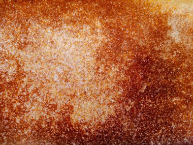 Paslı metal bir yüzeye yakın çekim, turuncu, kahverengi ve kırmızımsı tonlarda desenler sergiliyor..