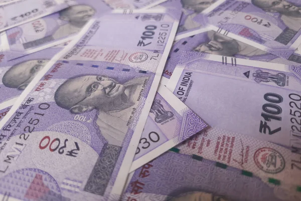 Indian one hundreds rupees bank note spread out randomly