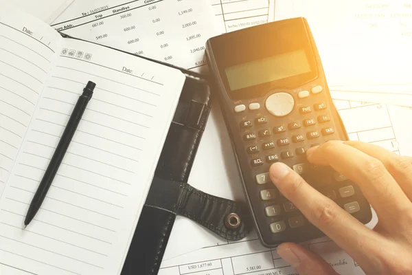 Savings, finances, economy and office concept - close up of man with calculator counting making notes, pen on the note book and bill at desk office, data analysis, soft focus. — Stock Photo, Image