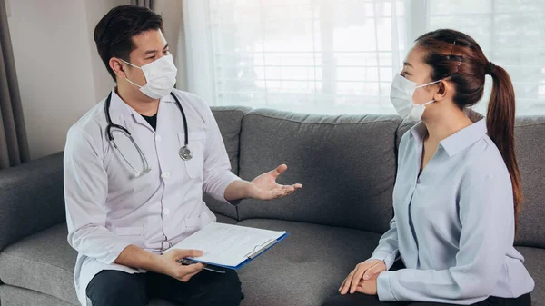 Doctor visited the patient while wearing a mask at home to check the patient treatment during the virus epidemic.