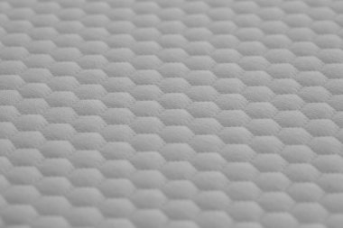 Yatak örtüsünün soyut beyaz dokusu veya yastık yüzeyi arkaplanı kapat