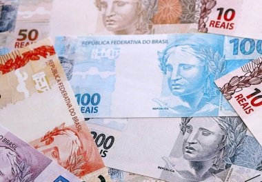 Brezilya 'nın gerçek para banknotları masaya yığılır. BRL para biriminin Brezilya banknotlarını kapatın. Brezilya 'da iş, ekonomi ve yatırım kavramı.