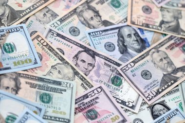 Masaya Amerikan dolarları yığılıyor. A.B.D. para birimi banknotları yakın plan. ABD 'de iş, ekonomi ve yatırım kavramı.