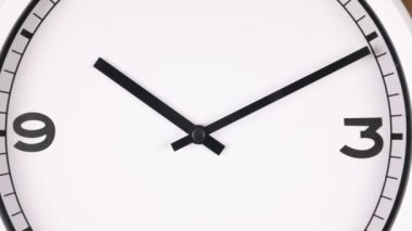 Spinning analog clock face showing the numbers 3 and 9