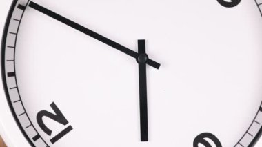 Spinning analog clock face showing the numbers 6 and 12