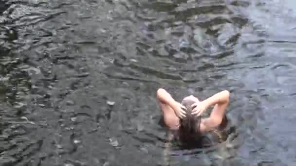 Junges hübsches Mädchen badet und wäscht Kopf in wildem Fluss und Wasserfall — Stockvideo