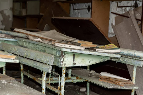 Школьные парты в классе заброшенной школы в Чернобыльской зоне отчуждения — стоковое фото