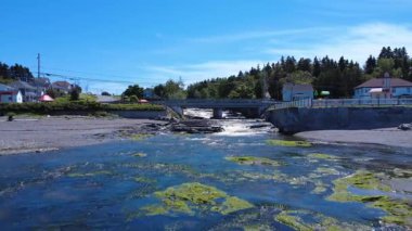 Rivire-Blanche 'ın ağzı, St. Lawrence Nehri' ne akar, beton bir yol köprüsünün altından geçer. Saint-Ulric-de-Matane, Quebec, Kanada, 2025.
