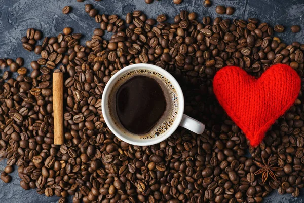 Love for coffee. Concept. Cinnamon, coffee beans, white Cup and heart