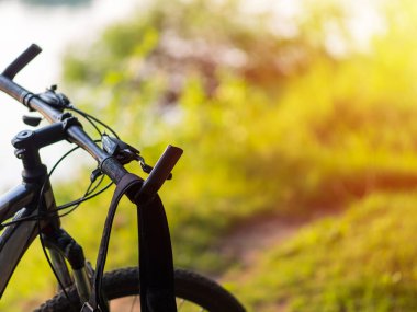 Close-up of mountain bike in the forest at sunset with copyspace