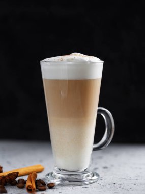 Coffee latte in a glass on a concrete table
