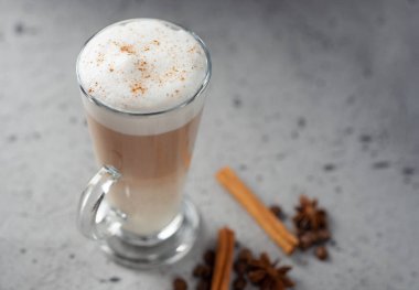 Coffee latte in a glass on a concrete table