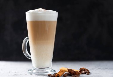 Coffee latte in a glass on a concrete table