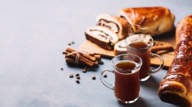 homemade pastries a poppy seed bun, a cup of coffee on the table