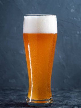 A glass of beer on a gray table