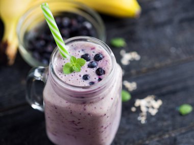 Böğürtlenli ve muzlu bir kavanoz koyu smoothie.