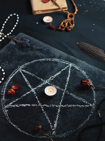 Kara büyü ayini, okültizm kavramı, tahtaya çizilmiş bir pentagram, eski bir büyü kitabı.