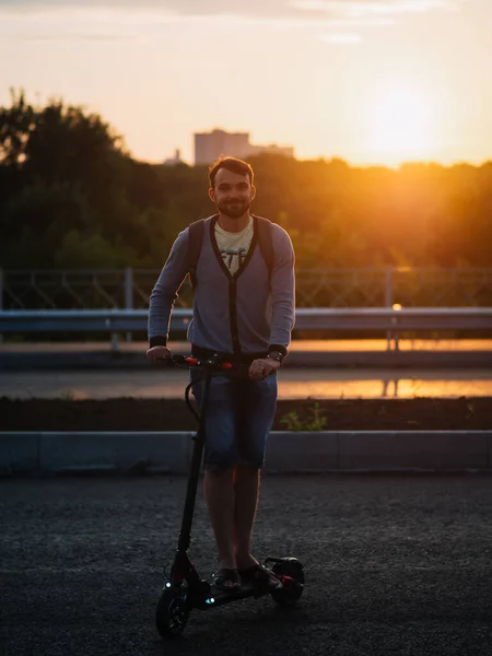 Man Rides Electric Scooter Sunset Ecotransport Future Summer Time — Stock Fotó