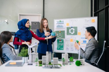 Bir grup alternatif enerji mühendisi, bir iş adamıyla bir projeyi tartışıyor güneş pili paneli ve Güneş Enerjisi Çevre Şehri Konsepti 'nde bir toplantı yapıyor. Ofiste.