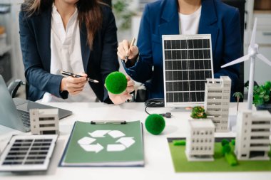 Group of alternative energy engineers discussing a project with a worker businesspeople a meeting in solar cell panel and Solar Energy Environment city Concept. in offic