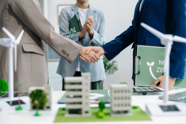 Business people having consultation about wind energy at company office. Business team discussing about windmill and alternative green energy. Executive meeting 