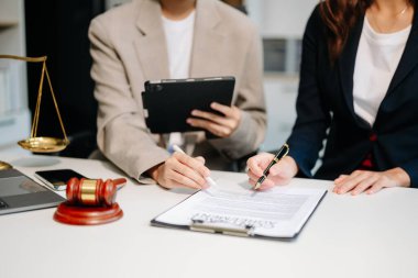 Business law concept, Lawyer business lawyers are consulting lawyers for women entrepreneurs to file copyright lawsuit with laptop and tablet at office