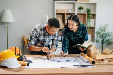 Engineer Teamwork Meeting, Drawing working on blueprint meeting for project working with partner on model building at company office. Asian industry professional team