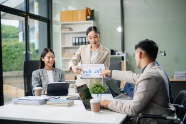 Yaratıcılık sektöründe tasarım planlama konusunda bir grup Asyalı iş toplantısı ofiste iş tartışması