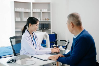 Asian female hands touching old male hand Helping hands take care of the elderly concept in hospita