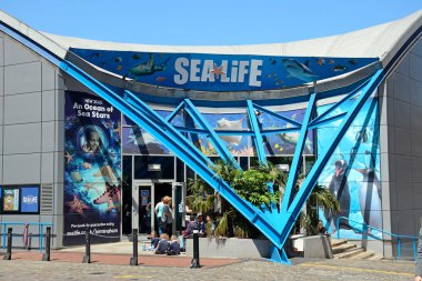 Front entrance to the National Sea Life Centre with a party of school children waiting to enter, Birmingham. clipart