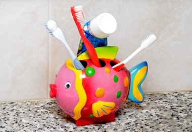 Fish toothbrush holder and brushes. clipart