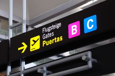 Airport gate signs at Malaga airport, Spain. clipart