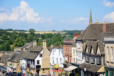 View of shops and businesses along The Hill shopping street during the Summertime, Burford clipart