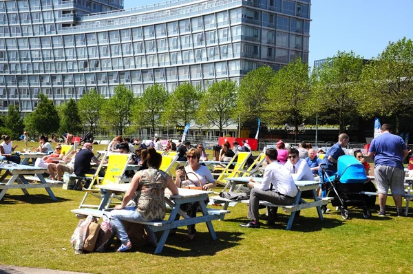Personas que se relajan en bancos de picnic en Chavasse Park durante el verano, Liverpool . — Foto de Stock