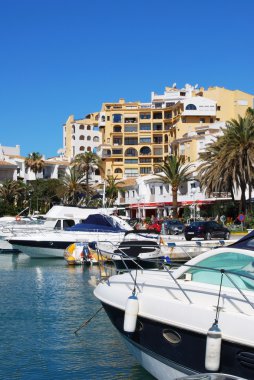 Boats in the marina with apartments and restaurants to the rear, Puerto Cabopino, Marbella. clipart