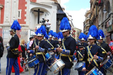 Members of the San Esteban brotherhood band marching through the city centre streets during Santa Semana, Seville. clipart