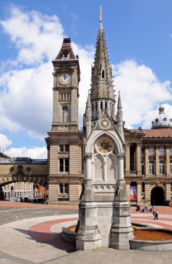Chamberlain memorial in Chamberlain Square with the clock tower of Birmingham museum and art gallery to the rear, Birmingham.