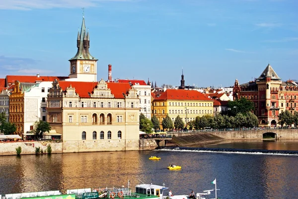 View from the Charles bridge of the Vltava River with the tower of the Smetana Museum (Muzeum Bedricha Smetany) to the rear, Prague. Royalty Free Stock Photos