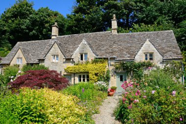 Pretty Cotswold cottages and gardens during the Summertime, Bibury. clipart